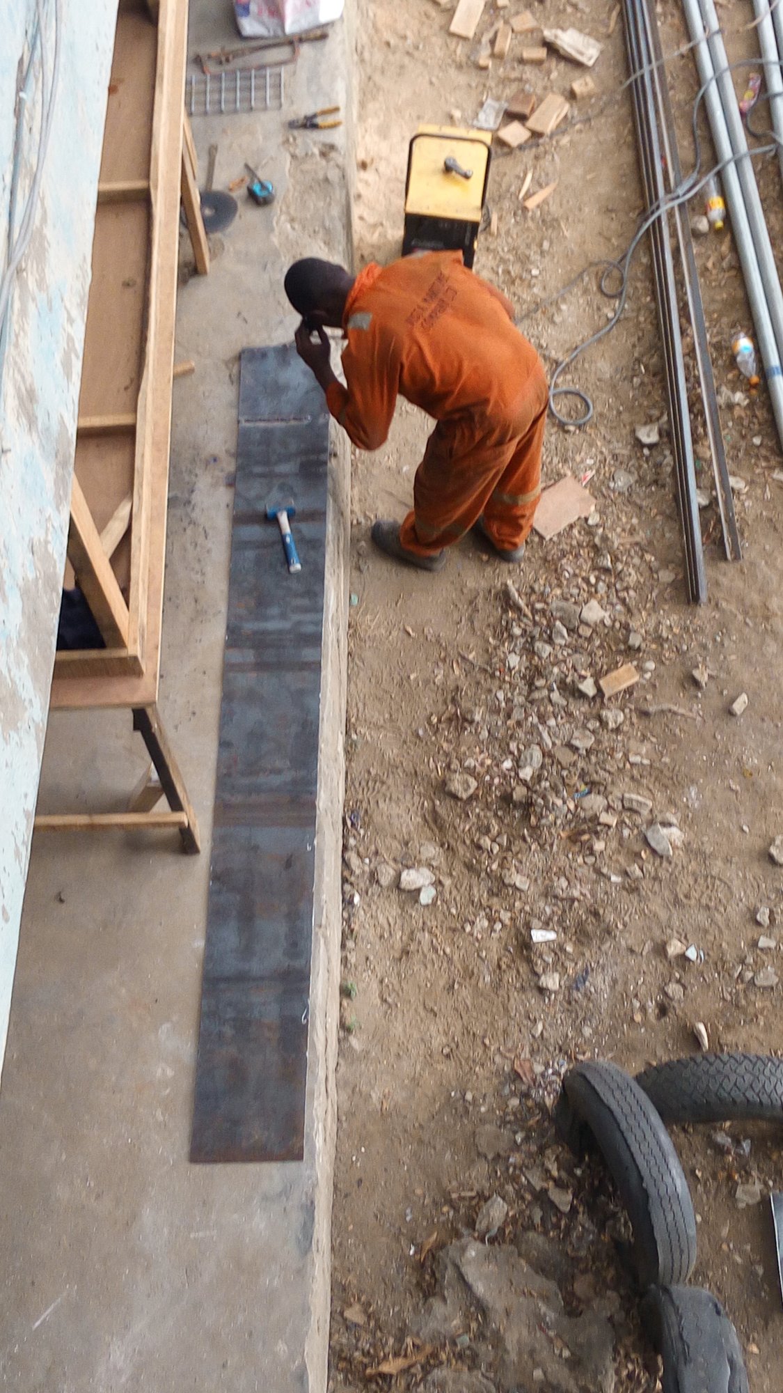 From Ebute: welding a long steel strip on the ground.