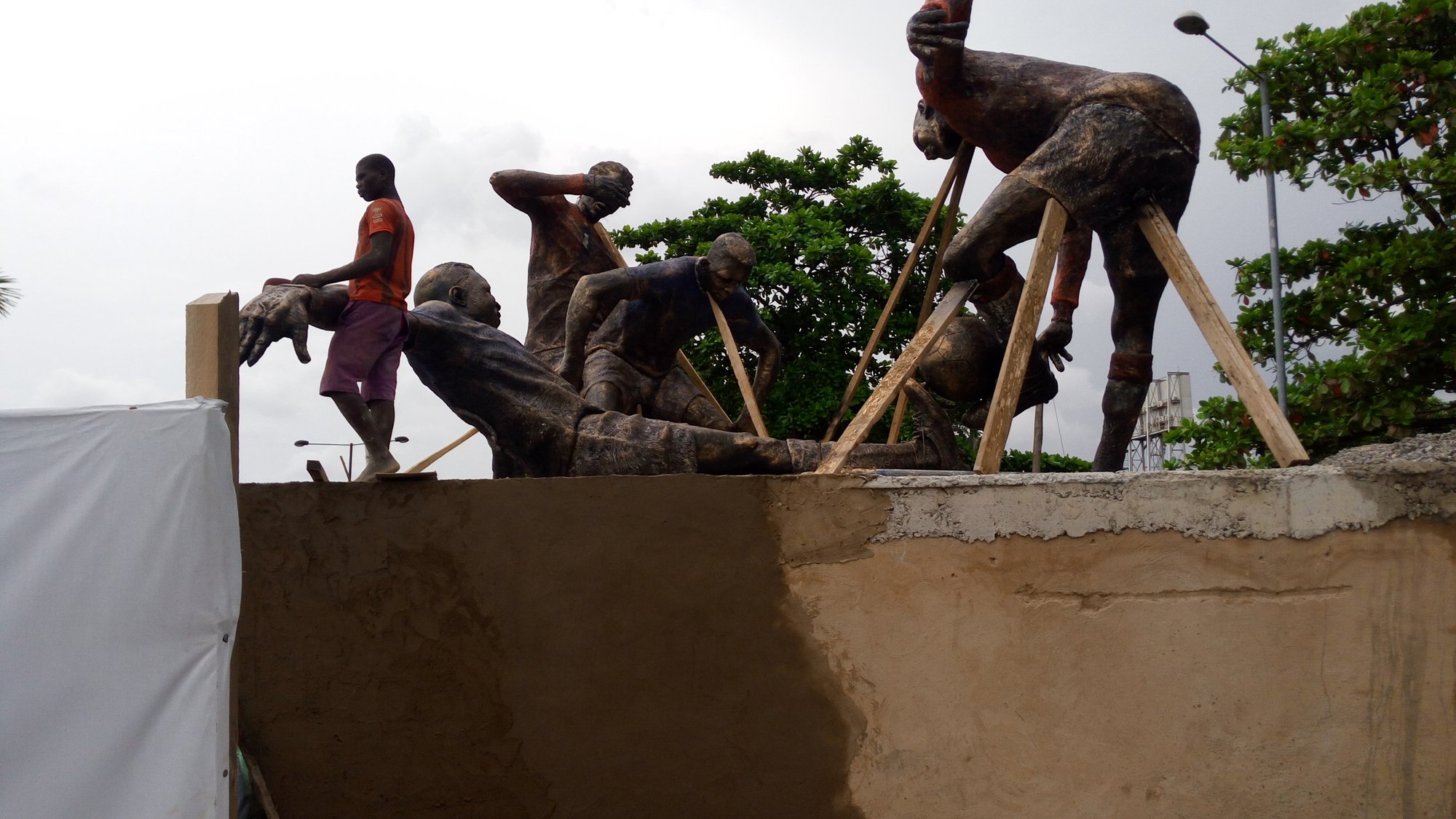 Football Forever: figures being set on the plinth on site.